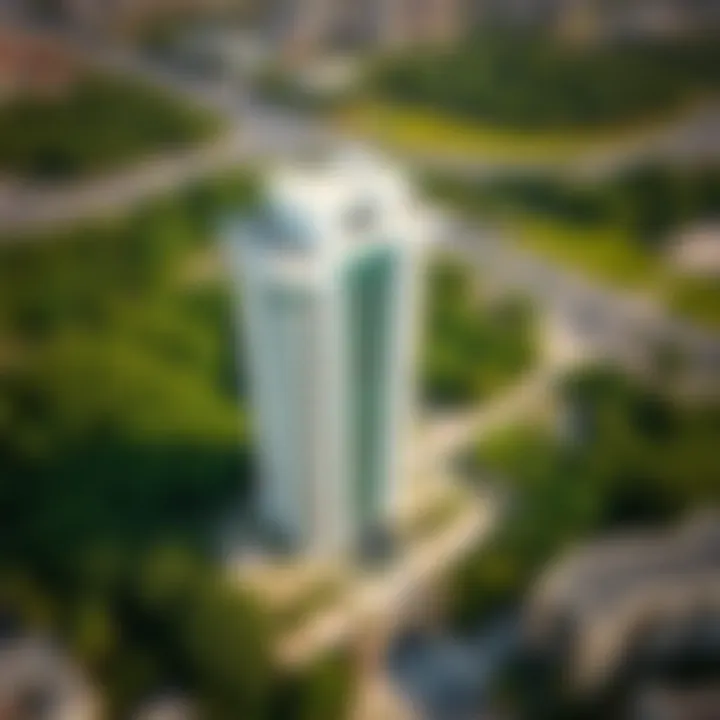 Aerial View of Al Reef Tower 1 Aerial perspective of Al Reef Tower 1 surrounded by lush greenery and urban development