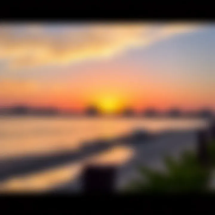 Sunset over Hudayriat Beach with silhouettes of development projects in the background.