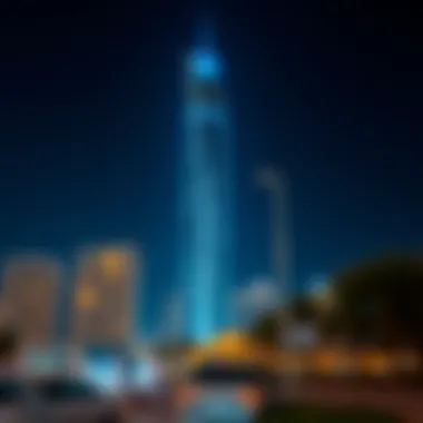 Night view of Rawan Tower illuminated against the Dubai skyline